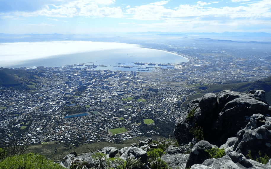 A view of the city of Cape Town showing the dock area bellow and part of the Cape Flats on the right hand side.